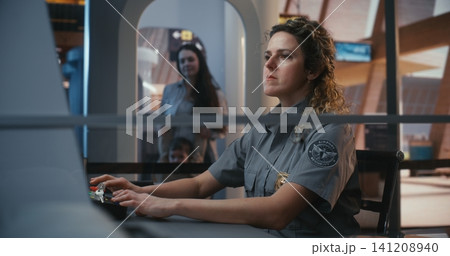 Uniformed Officer Managing Luggage Scanning System at Airport Entrance Uniformed Officer Managing Luggage Scanning System at Airport Entrance 141208940