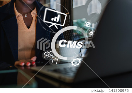 Using a content management system on a laptop for work in a modern office setting Using a content management system on a laptop for work in a modern office setting 141208976