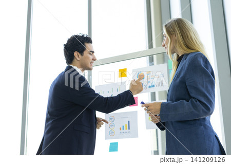 Man and woman businesspeople planning business strategy and shaking hands in office. Business, education and office concept. Man and woman businesspeople planning business strategy and shaking hands in office. Business, education and office concept. 141209126