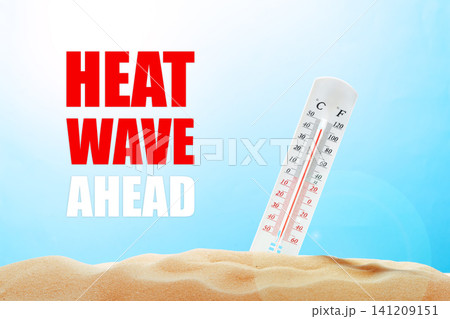 Heat wave warning with thermometer showing high temperatures and sandy background in bright sky Heat wave warning with thermometer showing high temperatures and sandy background in bright sky 141209151