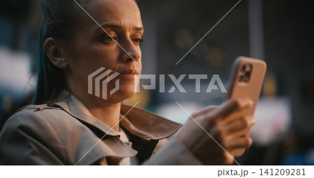 Female Passenger Verifying Flight Details Using Mobile Phone and Boarding Pass Female Passenger Verifying Flight Details Using Mobile Phone and Boarding Pass 141209281