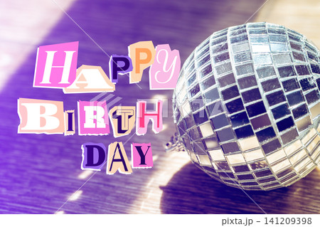 Celebrate happy birthday with a shiny disco ball and colorful letters on a wooden surface Celebrate happy birthday with a shiny disco ball and colorful letters on a wooden surface 141209398