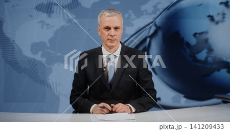 Serious News Presenter Finishing Live Report in Digital TV Studio 141209433