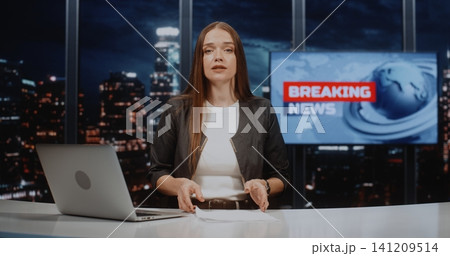 Confident Female Journalist Presenting Breaking News Report in Modern Television Studio 141209514