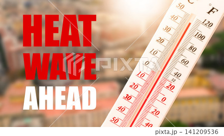 Heatwave warning shows high temperature on thermometer in urban area during sunny day 141209536
