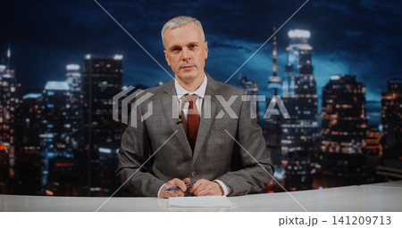 Professional News Presenter in Grey Jacket and Red Tie Delivering in depth News Analysis 141209713