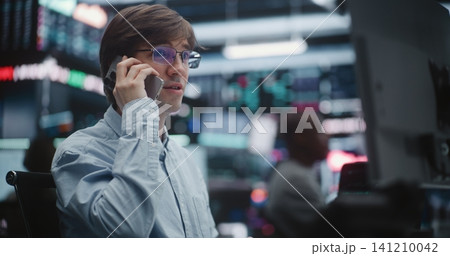 Focused Stock Broker Handling Communication Channels on Exchange Floor Focused Stock Broker Handling Communication Channels on Exchange Floor 141210042