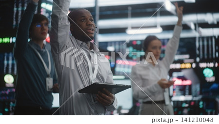 Multicultural Team of Professional Traders Standing in Active Trading Pit, Simultaneously Gesture Multicultural Team of Professional Traders Standing in Active Trading Pit, Simultaneously Gesture 141210048
