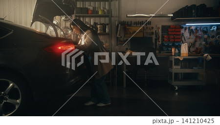 Female in Casual Outfit Carries Shopping Bags and Packages, Effortlessly Closing Trunk 141210425