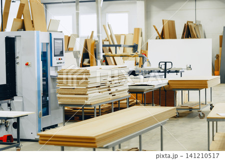 Carpentry work takes place in a busy furniture workshop on a bright day Carpentry work takes place in a busy furniture workshop on a bright day 141210517