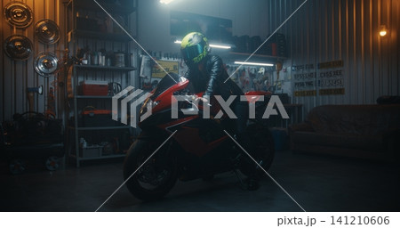 Stylish Woman in Black Leather Outfit Mounting Sport Motorcycle in Professional Garage Stylish Woman in Black Leather Outfit Mounting Sport Motorcycle in Professional Garage 141210606