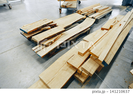 Furniture workshop displays various types of wooden planks and boards for crafting furniture 141210637