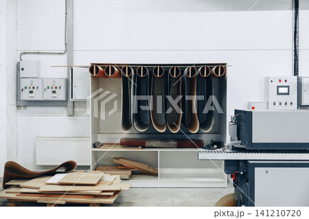 Furniture workshop with rolled materials stored on the wall and machinery on the right side Furniture workshop with rolled materials stored on the wall and machinery on the right side 141210720