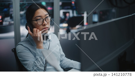 Professional Stock Exchange Operator Speaks on Landline Phone 141210778