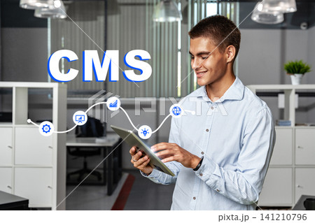Man working with a tablet in an office environment focused on content management systems Man working with a tablet in an office environment focused on content management systems 141210796