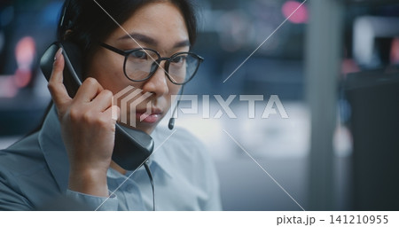 Female Stock Exchange Trader Manages Live Market Operations While Speaking on Landline Phone Female Stock Exchange Trader Manages Live Market Operations While Speaking on Landline Phone 141210955