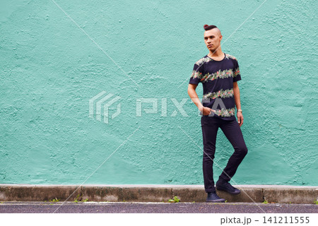 Man, confidence and serious outdoors for fashion, weekend and casual style for hipster trend. Male person, travel and mockup space by wall background, aesthetic and streetwear or clothes for attitude Man, confidence and serious outdoors for fashion, weekend and casual style for hipster trend. Male person, travel and mockup space by wall background, aesthetic and streetwear or clothes for attitude 141211555