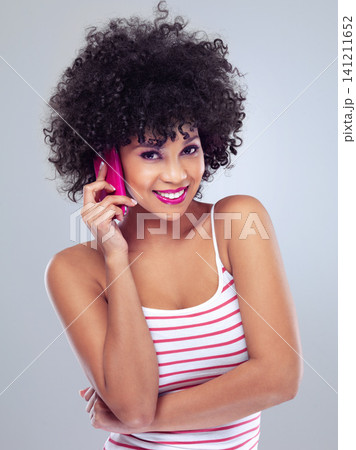 Black woman, smile with cellphone for phone call and communication, listen and lipstick on white background. Contact, chat and tech with afro hairstyle and pink makeup, app and connection in studio 141211652
