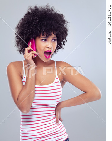 Black woman, cellphone for phone call and surprise announcement with news and lipstick on white background. Contact, chat and tech with afro hairstyle and pink makeup, wow or shock with reaction Black woman, cellphone for phone call and surprise announcement with news and lipstick on white background. Contact, chat and tech with afro hairstyle and pink makeup, wow or shock with reaction 141211721