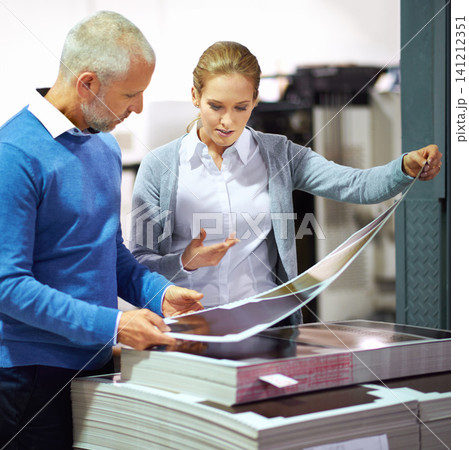 Warehouse, communication and business people with paper in printing industry, factory and creative sector for design project. Teamwork, man and woman talking, discussion and quality check of work Warehouse, communication and business people with paper in printing industry, factory and creative sector for design project. Teamwork, man and woman talking, discussion and quality check of work 141212351