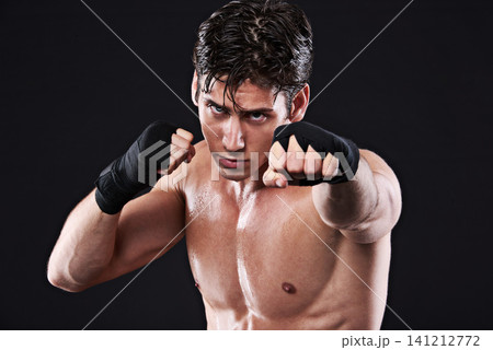 Sports, boxing and portrait or man training, workout and exercise for mma fighting in studio. Serious, male athlete and shirtless boxer, punch and strike in martial arts practice on black background Sports, boxing and portrait or man training, workout and exercise for mma fighting in studio. Serious, male athlete and shirtless boxer, punch and strike in martial arts practice on black background 141212772