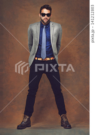 Suit, fashion and portrait of man with sunglasses and confidence in studio, background and mockup. Cool, style and model with pride for professional outfit or person with luxury designer clothes 141212803
