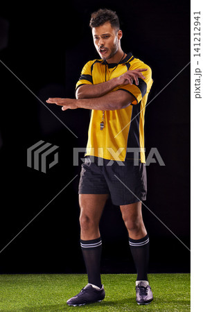 Man, referee and sport for soccer, rules and game for active and sportswear on grass or field. Arab person, sportsman or athlete with kit and practice for strong and competitive on dark background Man, referee and sport for soccer, rules and game for active and sportswear on grass or field. Arab person, sportsman or athlete with kit and practice for strong and competitive on dark background 141212941