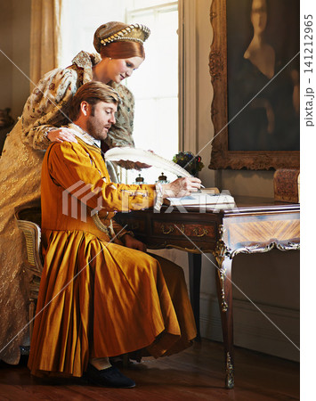 Couple, feather and writing a letter, royal and relax in home for history in noble palace. People, quill and bonding or notes in journal for plan, renaissance and aesthetic for support in marriage Couple, feather and writing a letter, royal and relax in home for history in noble palace. People, quill and bonding or notes in journal for plan, renaissance and aesthetic for support in marriage 141212965
