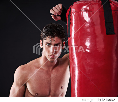 Fitness, mma and portrait of man with punching bag in studio for exercise, challenge or competition training. Power, muscle or champion boxer at workout with confidence, fight and black background Fitness, mma and portrait of man with punching bag in studio for exercise, challenge or competition training. Power, muscle or champion boxer at workout with confidence, fight and black background 141213032