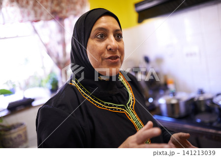 Muslim woman, happy and kitchen for family dinner and islam religion of halal cooking. Arabic, female and ideas with instruction on preparation of food, ramadan and traditional role in home in hijab Muslim woman, happy and kitchen for family dinner and islam religion of halal cooking. Arabic, female and ideas with instruction on preparation of food, ramadan and traditional role in home in hijab 141213039