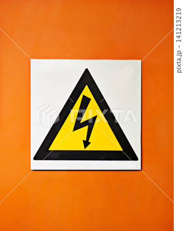 Warning, sign and voltage with triangle or symbol for alert, precaution or safety at warehouse or factory. Hazard poster or shape in beware of high wattage, electricity or power surge on mockup space Warning, sign and voltage with triangle or symbol for alert, precaution or safety at warehouse or factory. Hazard poster or shape in beware of high wattage, electricity or power surge on mockup space 141213219