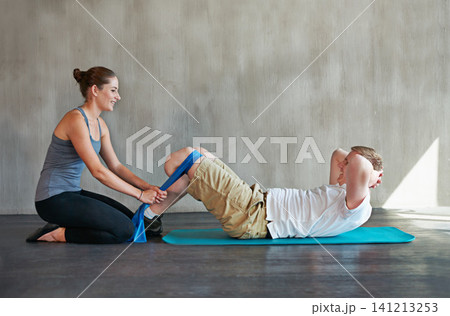 Man, woman and physiotherapy with prosthetic, amputee and leg at rehabilitation, exercise and training. Physiotherapist, patient and fitness for workout, band and routine for person with a disability 141213253
