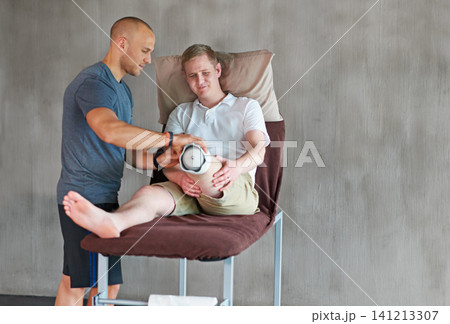 Therapist, man with disability or prothesis in healthy, recovery or teamwork in physical wellbeing. Person, physio or leg on bed as healthcare, support or assessment of medical fitting in exam mockup 141213307