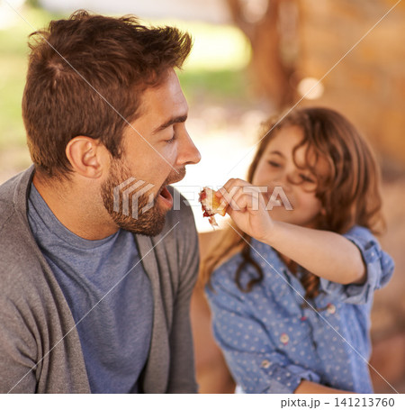 Happy father, food and girl feeding in morning on bench with family for breakfast, nutrition and happiness. Dad, child and meal outdoors for food, health and sharing with open mouth, smile and joy. 141213760