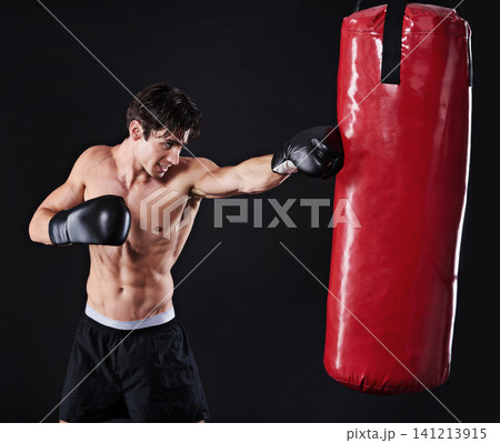 Man, athlete and punch on boxing bag with gloves for exercise workout, martial arts or black background. Male person, fist and fitness health as gym professional for fighter, mockup space or studio Man, athlete and punch on boxing bag with gloves for exercise workout, martial arts or black background. Male person, fist and fitness health as gym professional for fighter, mockup space or studio 141213915