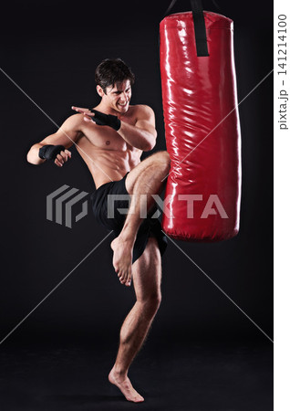 Man, fighter and boxing bag with kick in studio for self defence workout, martial arts or black background. Male person, wellness and mockup space for strength training with gym, fitness or sport Man, fighter and boxing bag with kick in studio for self defence workout, martial arts or black background. Male person, wellness and mockup space for strength training with gym, fitness or sport 141214100
