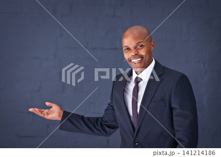 Happy, portrait and black man with presentation for advertising, show or speech on a gray studio background. African male person, businessman or young speaker with smile for marketing on mockup space Happy, portrait and black man with presentation for advertising, show or speech on a gray studio background. African male person, businessman or young speaker with smile for marketing on mockup space 141214186