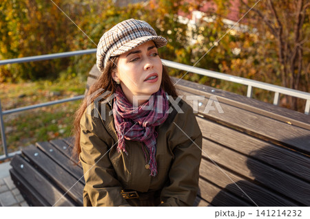 Woman gesturing while looking at smartphone 141214232