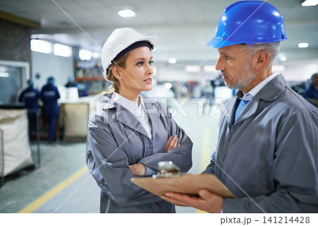 Man, woman and communication with clipboard in factory for quality inspection or safety checks and process monitoring. Team, conversation and board for manufacturing information in printing warehouse Man, woman and communication with clipboard in factory for quality inspection or safety checks and process monitoring. Team, conversation and board for manufacturing information in printing warehouse 141214428