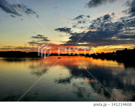 Vibrant Pink and Orange Sunset Sky over Lake Horizon Vibrant Pink and Orange Sunset Sky over Lake Horizon 141214608