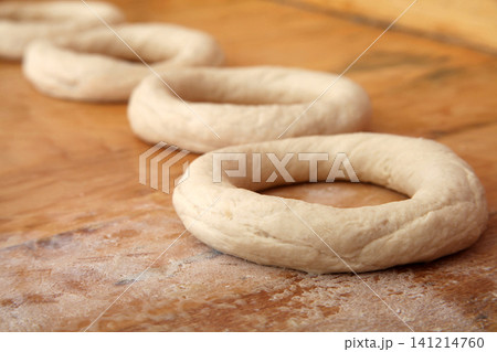 Making Turkish sesame bagels. Simit Making Turkish sesame bagels. Simit 141214760