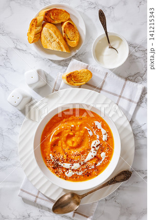 spiced sweet potato soup in a white bowl spiced sweet potato soup in a white bowl 141215343