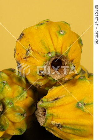 Group of whole raw exotic yellow pitahaya dragonfruits Group of whole raw exotic yellow pitahaya dragonfruits 141215388