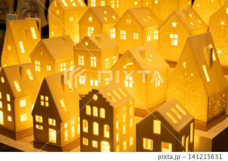 Glowing ceramic miniature houses with warm internal light 141215631