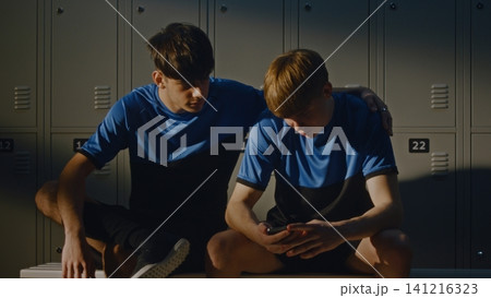 Two Teenage Footballers Talking in Modern Locker Room Two Teenage Footballers Talking in Modern Locker Room 141216323