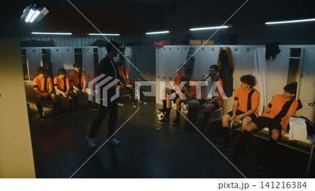 Angry Coach Shouting at Teenage Football Team in Locker Room After Loss 141216384