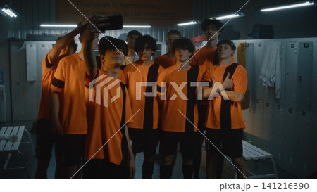 Teenage Soccer Players Gathers in Locker Room after Practice to Capture Cheerful Team Selfie Teenage Soccer Players Gathers in Locker Room after Practice to Capture Cheerful Team Selfie 141216390