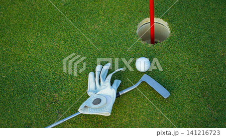 Golf balls on a green lawn in a beautiful golf course with morning sunshine. 141216723