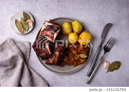 Grilled ribs with sauerkraut and potatoes 141216769