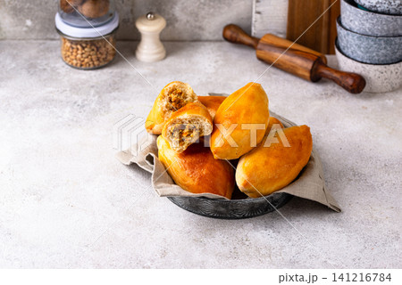 Traditional baked pies pirozhki with meat. Traditional baked pies pirozhki with meat. 141216784